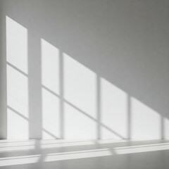 Obraz premium Soft natural light casts geometric window shadows on a plain white wall, creating a minimalist and tranquil aesthetic. The interplay of light and shadow adds depth and a serene, airy atmosphere