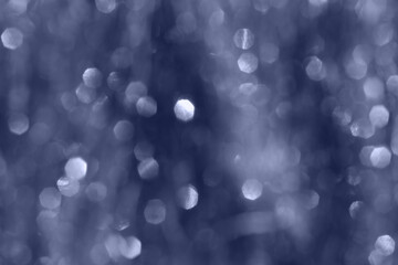 Vibrant abstract image with soft-focus dark blue bokeh light patterns with shimmering highlights,...