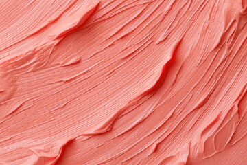 Coral pink frosting spread across a surface, smooth texture, use for baking goods