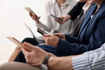 Group of people using different gadgets indoors, closeup. Modern technology