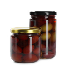 Pickled olives in glass jars isolated on white