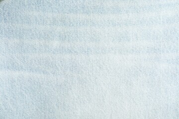 Texture of light blue jeans as background, top view