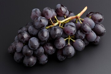 Fototapeta premium Bunch of fresh dark grapes on a dark background for healthy food promotion