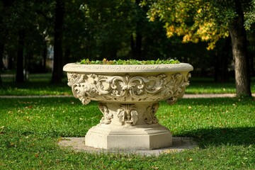 Ornate stone flowerpot in park