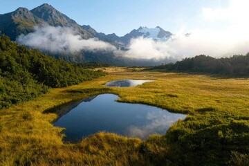 Misty mountain valley with mirrored ponds. Scenic view.  Possible use for nature wallpaper