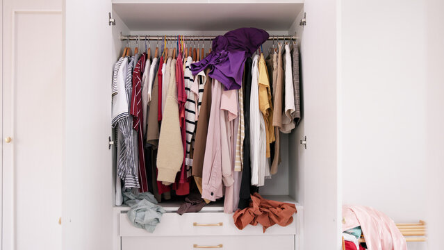 No people shot of messy used dirty heap clothes neat arrange need clean house room service. Home chores open dresser rack old walk-in closet stack fabric garment fast fashion industry waste issue.