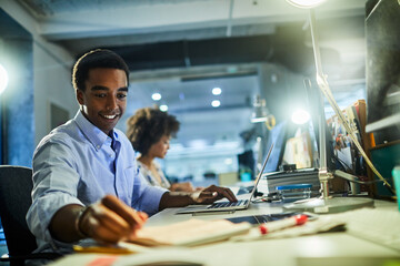 Young people working in a startup company office and using smart phones