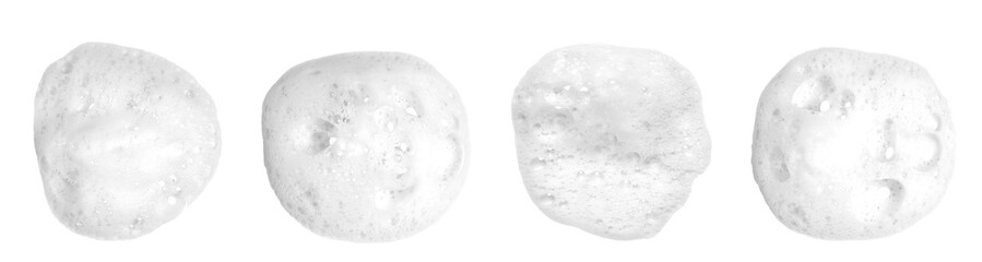Liquid white foam from soap, shampoo or bath foam. Abstract soap bubbles. Set of soap bubbles. Separated soap bubbles on white background with contrasting texture.

