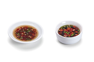 Fish sauce with chilli in a small cup isolated on white background.