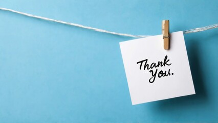 Thank You Concept with White Paper, Cursive Writing, Clothespins, and Blue Background  Gratitude and Appreciation Theme