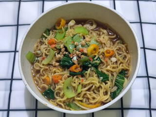 Soy sauce fried noodles served with pickles, chilies, vegetables, etc.