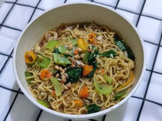 Soy sauce fried noodles served with pickles, chilies, vegetables, etc.