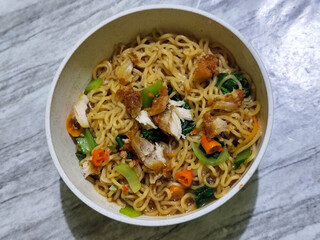 Soy sauce fried noodles served with pickles, chilies, vegetables, etc.