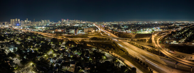 Above view of wide highway crossroads in Miami, Florida at night with fast driving cars. USA...