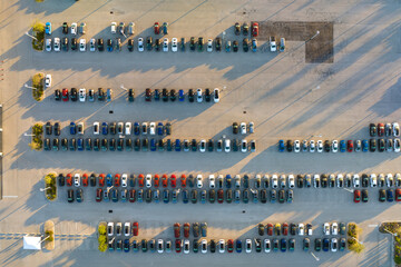 Obraz premium Aerial view of dealership parking lot with many brand new cars for sale. Development of american automotive industry concept