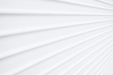 Obraz premium Close up of white textured wall with diagonal shadow pattern