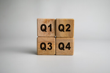concept of quarterly report on wooden cubes isolated on white background