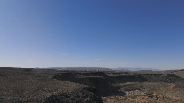 HURRICANE, UTAH, USA - February 07, 2025: Aerial-Flying rim of basalt cliffs-Virgin River below
