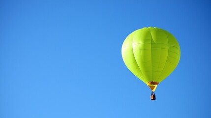 Fototapeta premium Lime Green Hot Air Balloon Soaring in a Clear Blue Sky