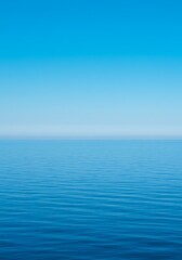 Obraz premium Calm Blue Ocean Meets the Horizon Under a Clear Azure Sky