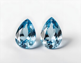 Fototapeta premium Two Blue Topaz Pear-Shaped Gemstones on White Background