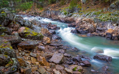 Water autumn landscape. A shallow fast mountain river with a rocky bottom. Ural.