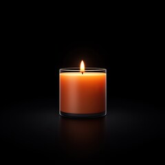 A single, lit amber candle in a clear glass jar sits on a dark surface.  The flame is bright against the black background.
