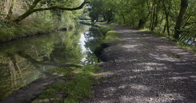 wide shot looking up the neath canal at resolven basin and locks