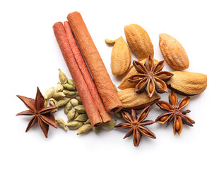 Star anise with cinnamon sticks, cardamom seeds and almond on white background, top view