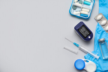 Composition with pulse oximeter, rubber gloves and medicines on white background