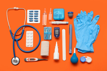 Composition with pulse oximeter, medical supplies and medicines on orange background