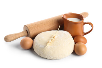 Composition with wooden rolling pin, dough and ingredients isolated on white background
