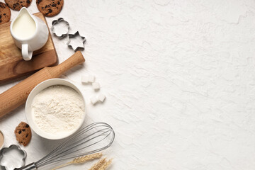 Composition with wooden rolling pin, kitchen utensils and ingredients for dough on white background