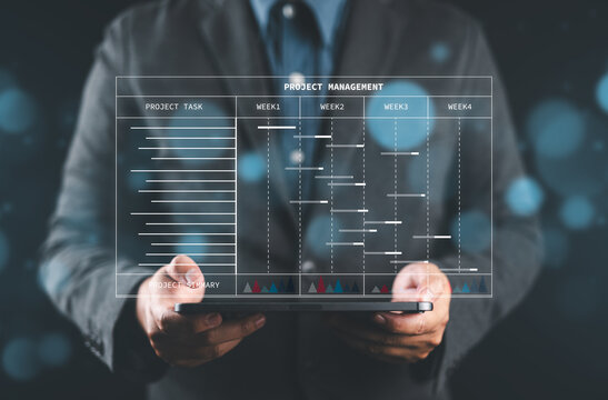 Efficient Project Management. Engineer or site manager utilizes tablet for construction planning with Gantt charts. Track engineering progress, update tasks, and generate reports seamles
