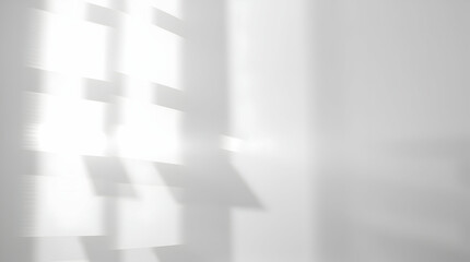 Abstract, blurred pattern of light and shadow creating a geometric design on a white surface.