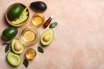 Composition with avocados and oil on beige background