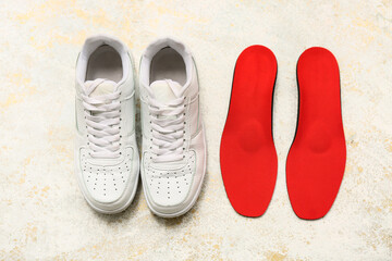 Shoes with orthopedic insoles on light background