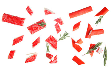 Cut tasty crab sticks and rosemary flying on white background © Pixel-Shot