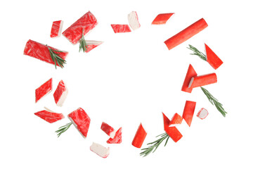 Frame made of cut tasty crab sticks and rosemary flying on white background © Pixel-Shot