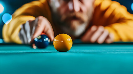 Man playing pool, aiming at yellow ball, dark bar, leisure activity