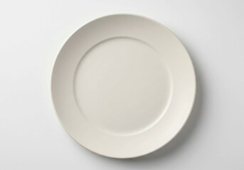 Against a white backdrop, a pristine white dinner plate highlights minimalist elegance and provides a blank slate for culinary art