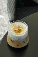 caramel coffee on wooden table. Cold coffee drink frappe frappuccino.