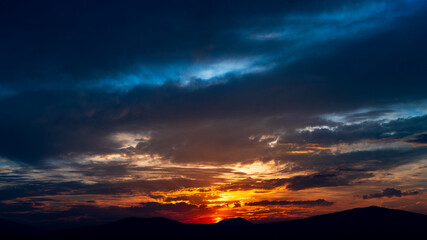 Cloudy sunset with sun gone behind the mountains in the lake of Patzcuaro, Michoacan, Mexico. The photo was taken from Yunuen Island.