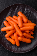 Raw peeled mini baby carrots as an ingredient for preparing a vegetarian food