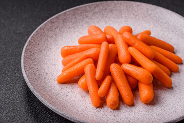 Raw peeled mini baby carrots as an ingredient for preparing a vegetarian food