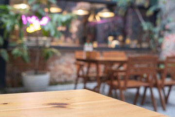 Background cafe wood counter blur effect, dark yet cozy ambiance in the restaurant, Table in kitchen, drink wooden desk bokeh light, abstract design for a modern space.