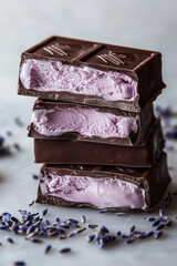 Dark chocolate bar with purple lavender caramel filling, elegant dessert. Open cut pieces in stack