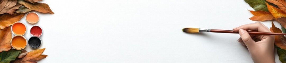 Close-up image of a hand holding a paintbrush with autumn leaves and paint on a white canvas isolated on a white background. Generative AI