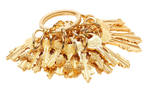 Golden keys bunch isolated on white. Useful for real estate, security, or design inspiration