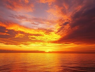 Obraz premium Beautiful sunset over the sea with an orange sky and golden clouds. Stunning seascape, ocean view with the sun setting in summer. Sunset background for design, print, or postcard.